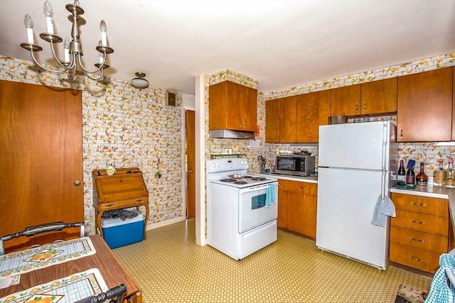 kitchen featuring decorative backsplash, white appliances, and a chandelier