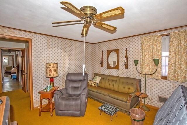 living room with carpet floors, crown molding, ceiling fan, and a healthy amount of sunlight