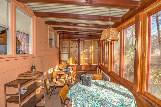 sunroom featuring beamed ceiling