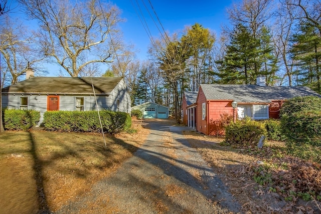 view of side of property with an outdoor structure and a garage