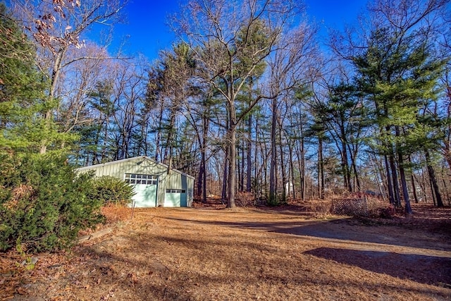 view of yard featuring an outbuilding and a garage