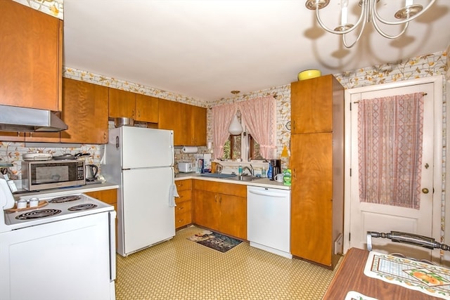 kitchen with sink, an inviting chandelier, white appliances, and ventilation hood