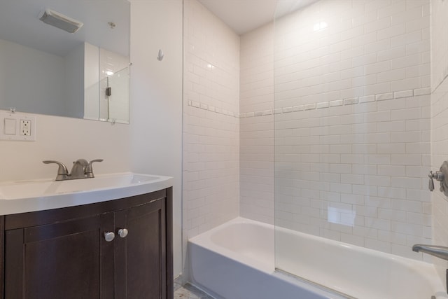 bathroom with vanity and tiled shower / bath combo