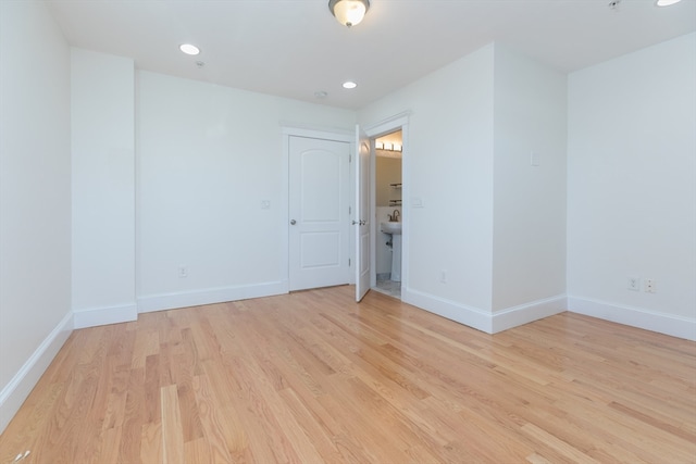 unfurnished room with light wood-type flooring