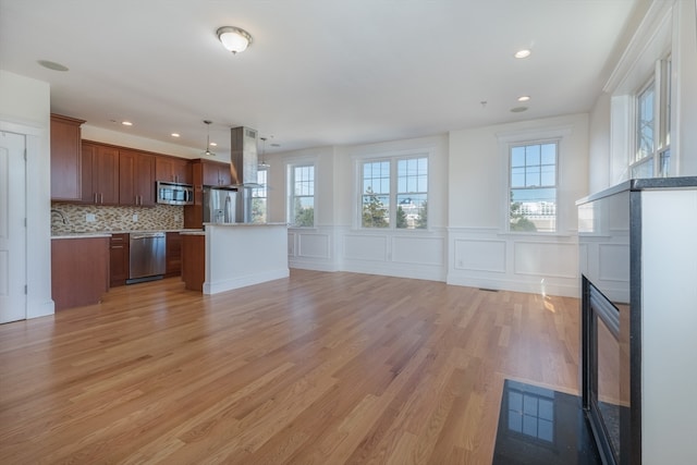 unfurnished living room with light wood-type flooring