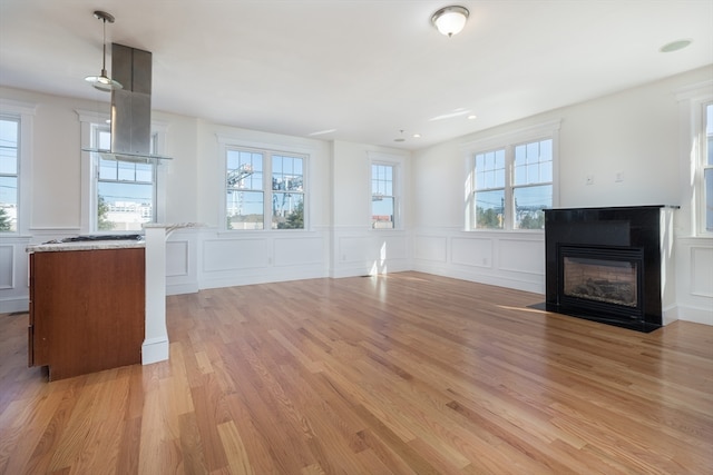 unfurnished living room featuring light hardwood / wood-style floors