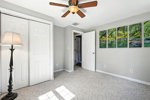 unfurnished bedroom featuring visible vents, a closet, baseboards, ceiling fan, and light colored carpet