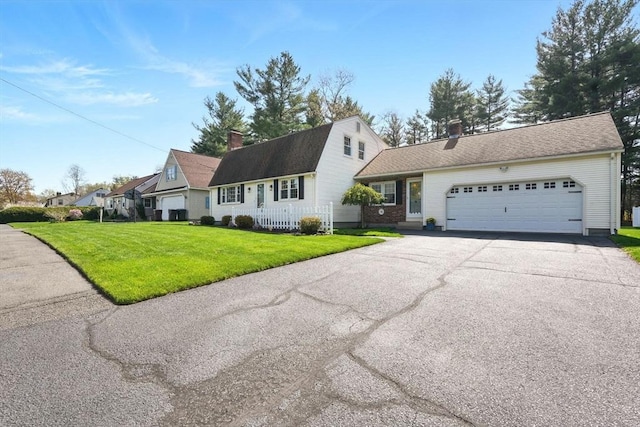 dutch colonial with an attached garage, a front lawn, aphalt driveway, and a chimney