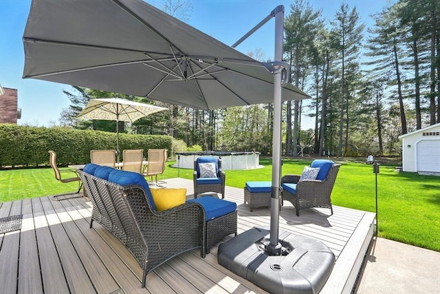 wooden deck featuring a lawn, a swimming pool, and an outdoor hangout area