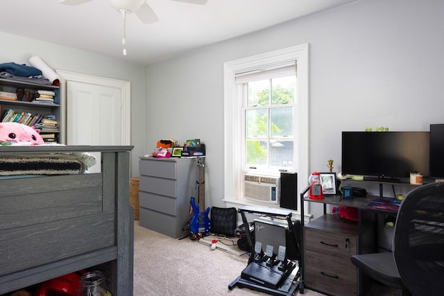 carpeted bedroom with an office area, cooling unit, and a ceiling fan