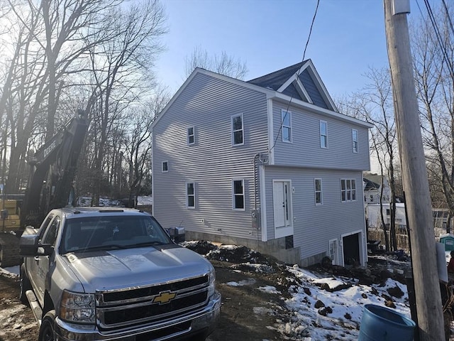 view of snow covered exterior featuring a garage