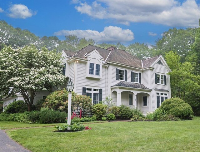 83 High Ridge Rd, Boxford, MA 01921 - view of front of house featuring a front lawn, a porch, a standing seam roof, and a metal roof
