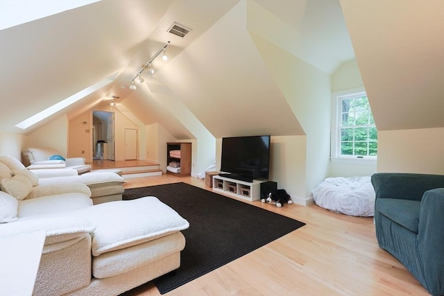 83 High Ridge Rd, Boxford, MA 01921 - living room featuring rail lighting, lofted ceiling, and wood finished floors