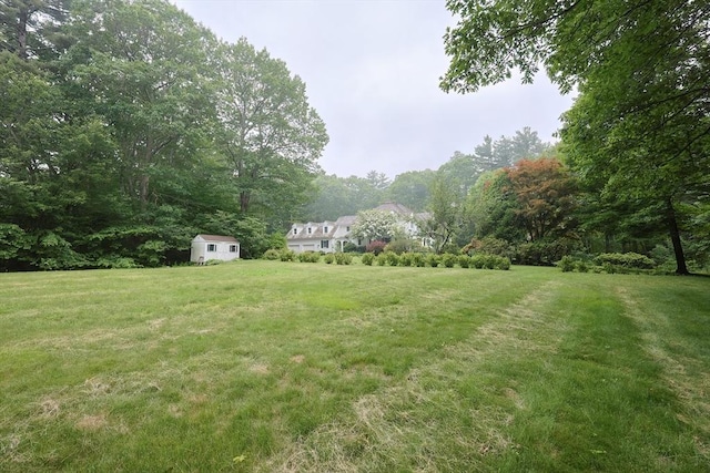 83 High Ridge Rd, Boxford, MA 01921 - view of grassy yard with a storage unit and a forest view