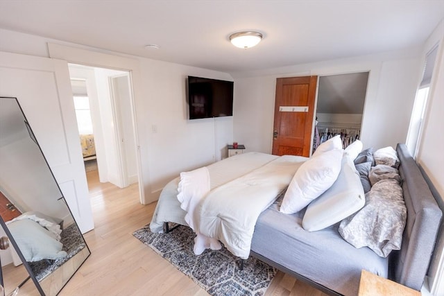 bedroom with light wood-style floors and baseboards