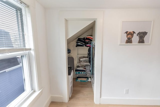 interior space with baseboards and light wood-style flooring
