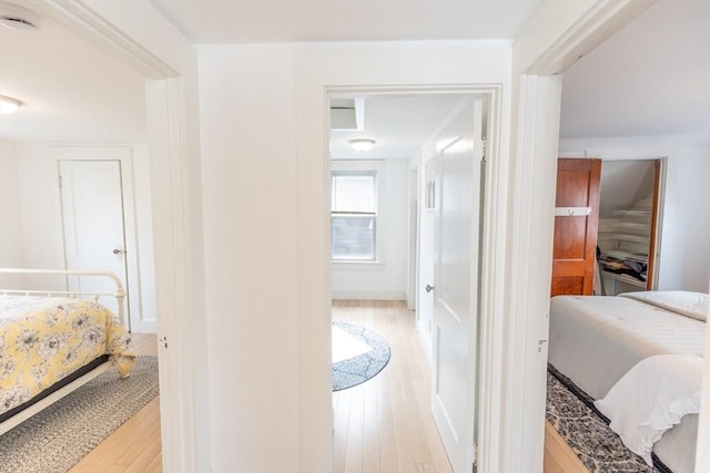 bedroom featuring light wood-style floors and baseboards