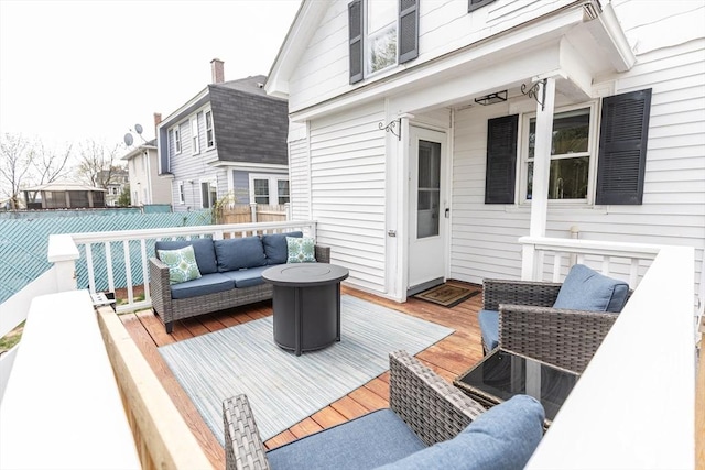 wooden deck featuring fence, a residential view, and an outdoor hangout area