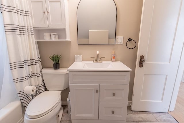 full bath with toilet, wood finished floors, and vanity