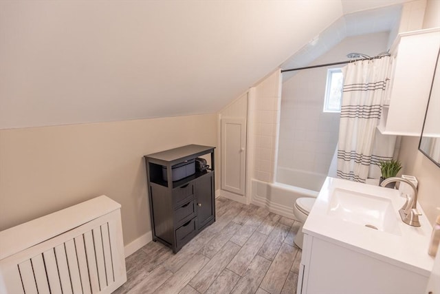 bathroom with vanity, shower / tub combo with curtain, lofted ceiling, wood finished floors, and toilet