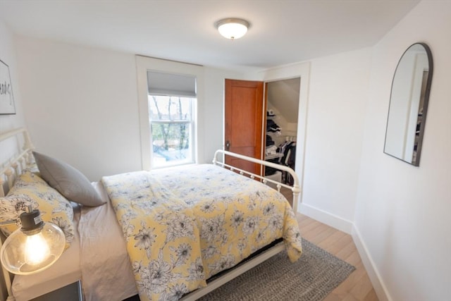 bedroom featuring baseboards and light wood-style flooring
