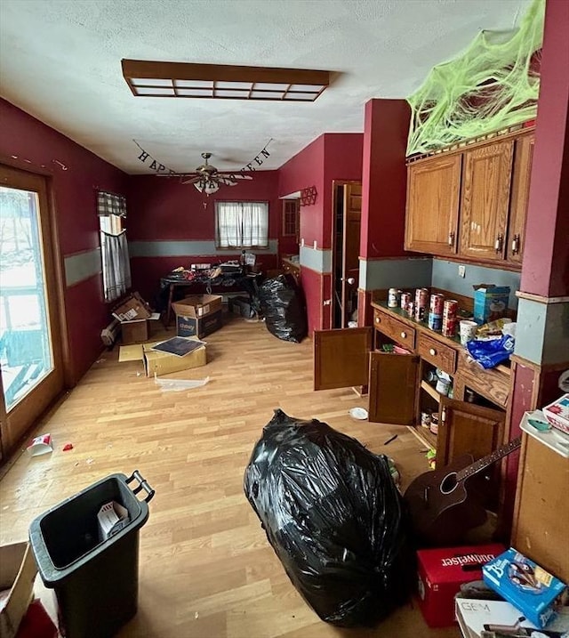 kitchen with ceiling fan, light hardwood / wood-style floors, and a textured ceiling