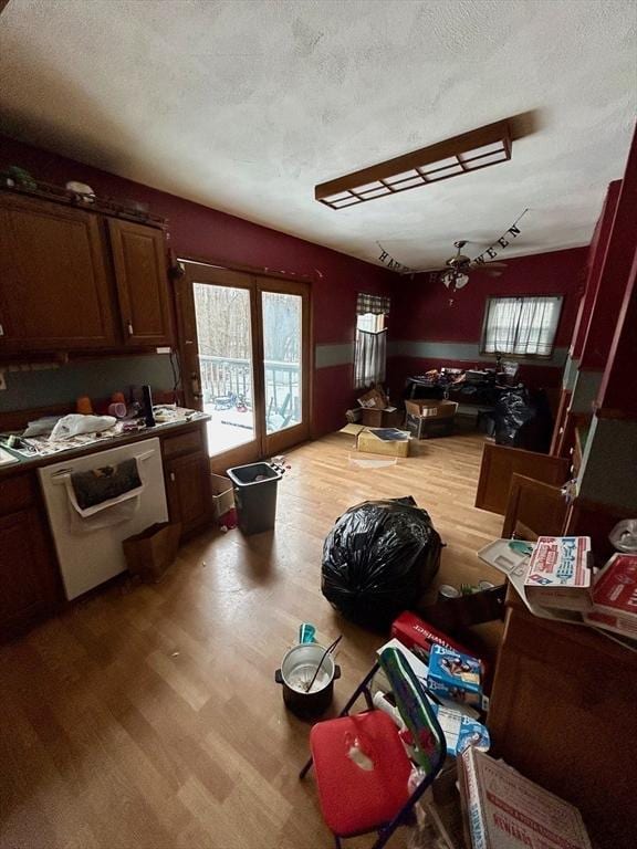 kitchen featuring hardwood / wood-style flooring, dishwasher, and a textured ceiling