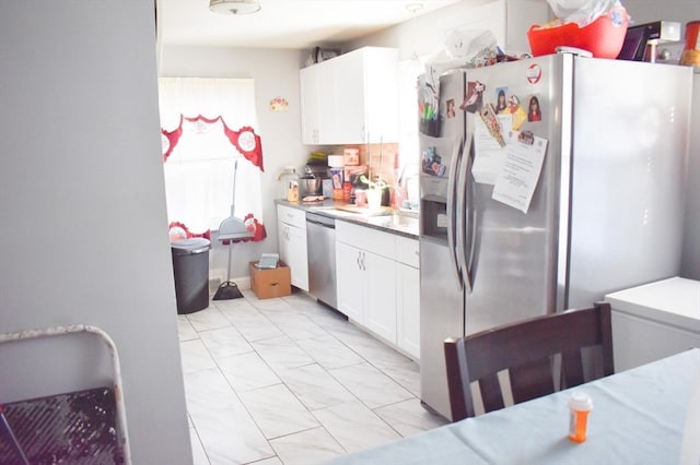 kitchen with white cabinetry and appliances with stainless steel finishes