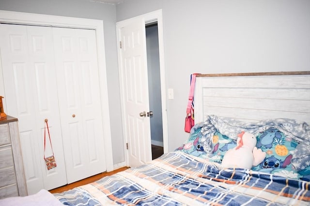 bedroom with hardwood / wood-style flooring and a closet