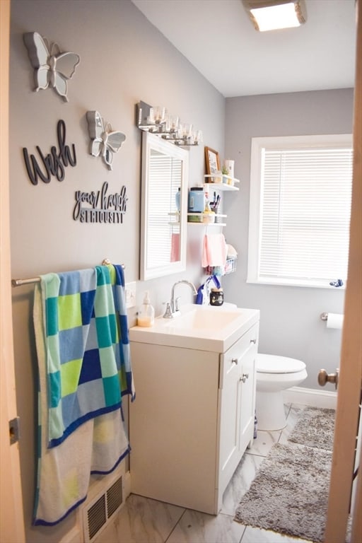 bathroom with vanity and toilet