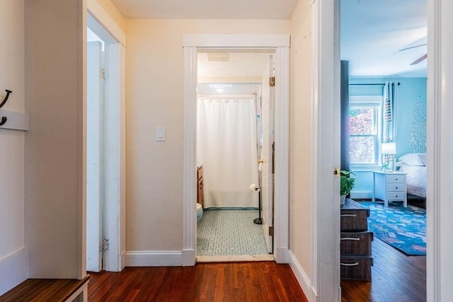 hallway with wood finished floors and baseboards