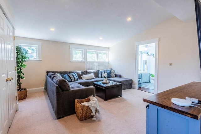living room featuring light colored carpet, healthy amount of natural light, baseboards, and recessed lighting
