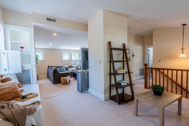 living area featuring light colored carpet, baseboards, and recessed lighting