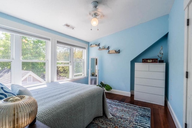 bedroom featuring baseboards, wood finished floors, and a ceiling fan