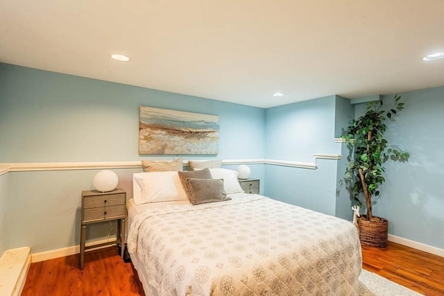 bedroom with baseboards, recessed lighting, and wood finished floors