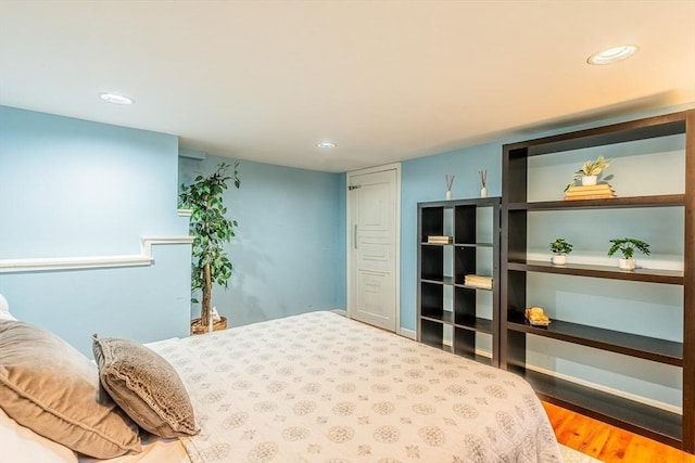 bedroom featuring wood finished floors and recessed lighting