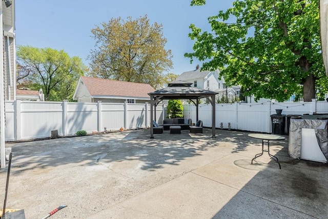 view of patio / terrace featuring an outdoor living space, a gazebo, and a fenced backyard