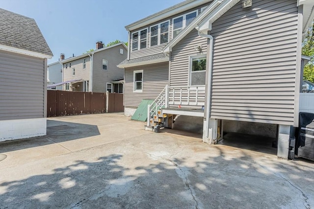 back of house featuring fence