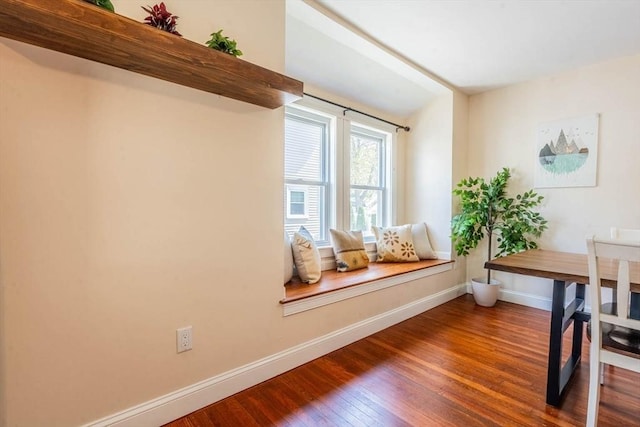 dining room with hardwood / wood-style flooring and baseboards