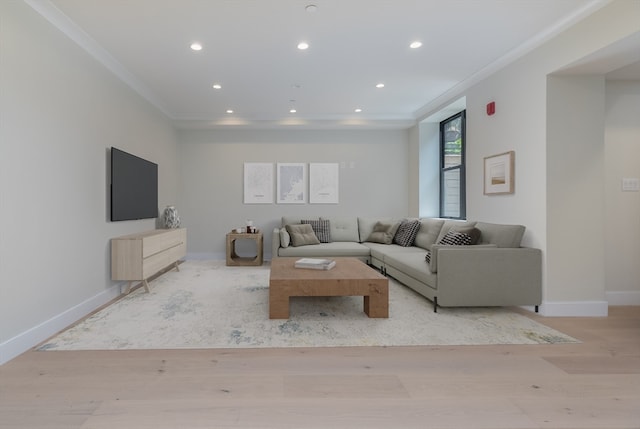 unfurnished living room featuring ornamental molding and light hardwood / wood-style flooring