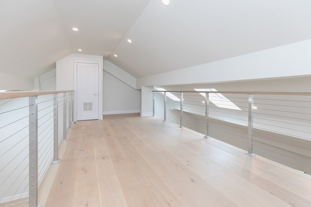 bonus room featuring light hardwood / wood-style flooring and vaulted ceiling