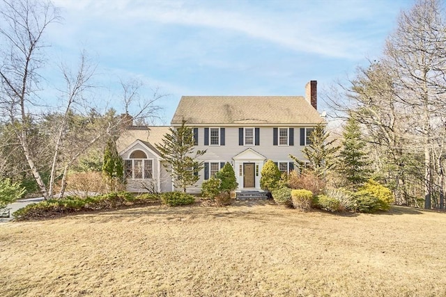 colonial-style house with a chimney