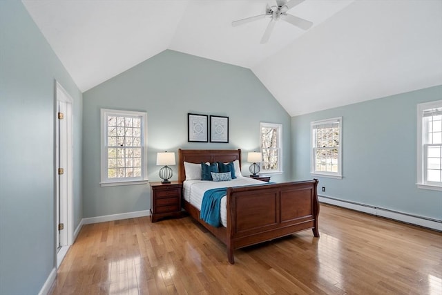 bedroom with light wood finished floors, ceiling fan, baseboards, lofted ceiling, and a baseboard radiator