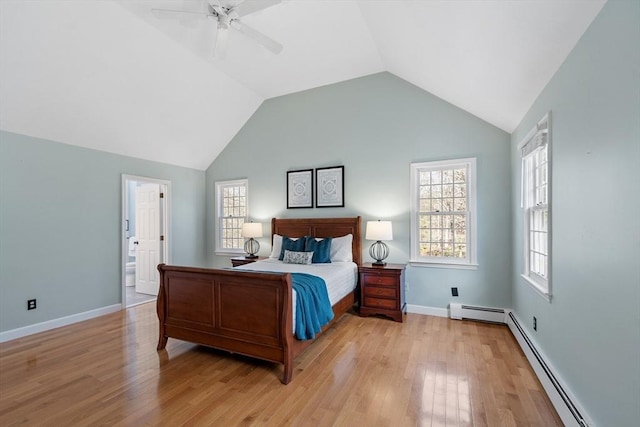 bedroom with light wood-type flooring, a baseboard heating unit, baseboards, and vaulted ceiling