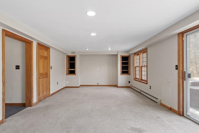 spare room with a baseboard heating unit, recessed lighting, light colored carpet, and baseboards