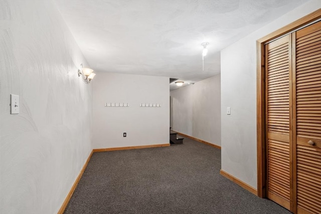 basement featuring carpet flooring and baseboards