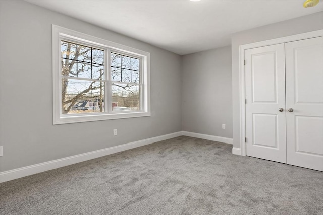 unfurnished bedroom with a closet and light carpet