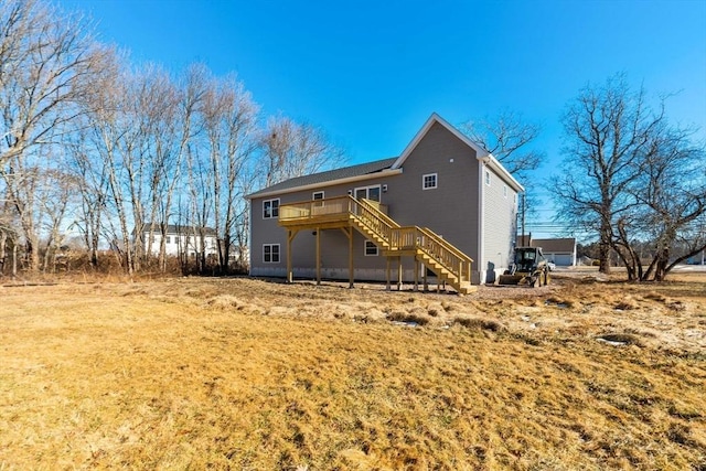 rear view of house featuring a yard and a deck