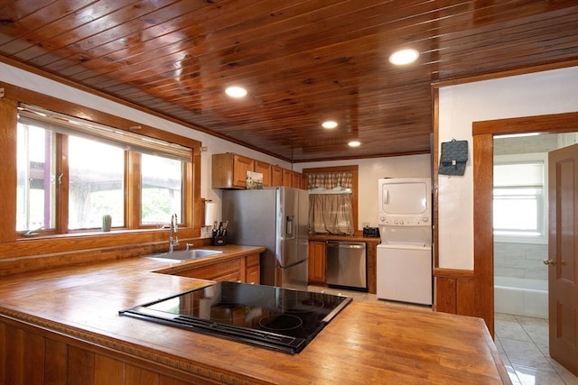 18 Morton St, Brockton, MA 02301 - kitchen with stainless steel appliances, wooden ceiling, stacked washer / dryer, crown molding, and recessed lighting