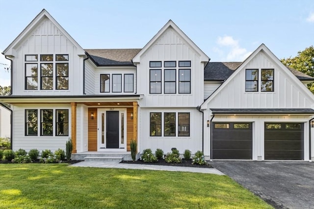 modern inspired farmhouse with a garage and a front yard